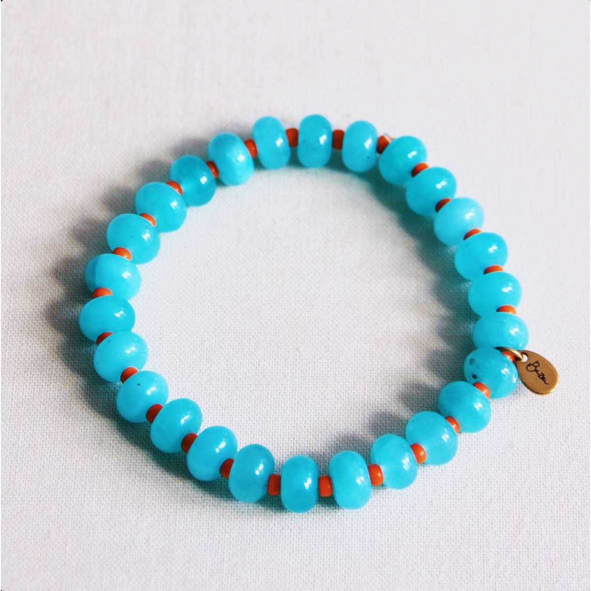 Elastische armband met edelstenen - turquoise/oranje