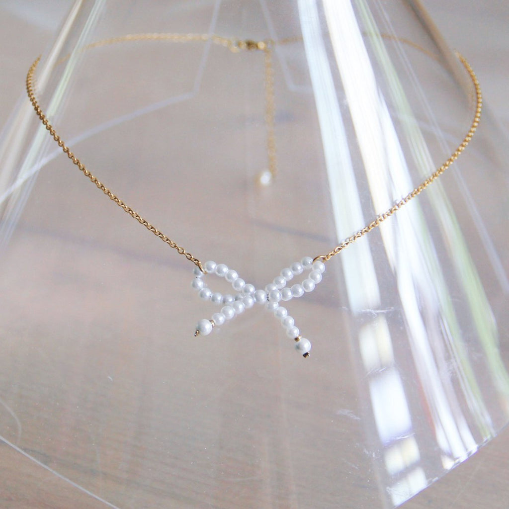 Edelstalen fijne ketting met parelstrik - goud